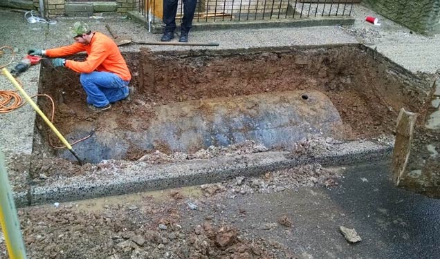 Oil tank uncovered and ready to be cut - OilTankAssurance.com